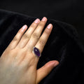 oval cabochon dark purple stone